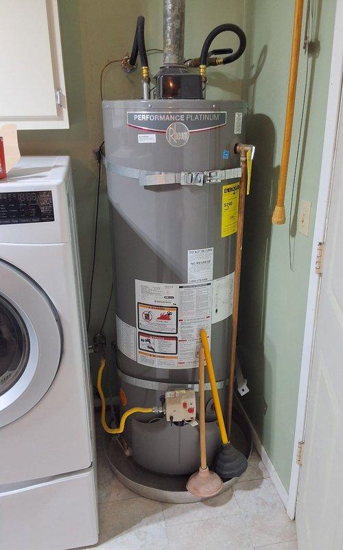 Replaced a 10-year-old 40-gallon electric water heater with a new Rheem Performance Platinum 40-gallon electric unit. Removed the existing failed water heater, installed the new unit with proper connections including pressure relief valve piping, electrical connections, and water supply lines. Discussed permit requirements with property owner and confirmed all necessary documentation would be obtained for the installation to ensure code compliance.