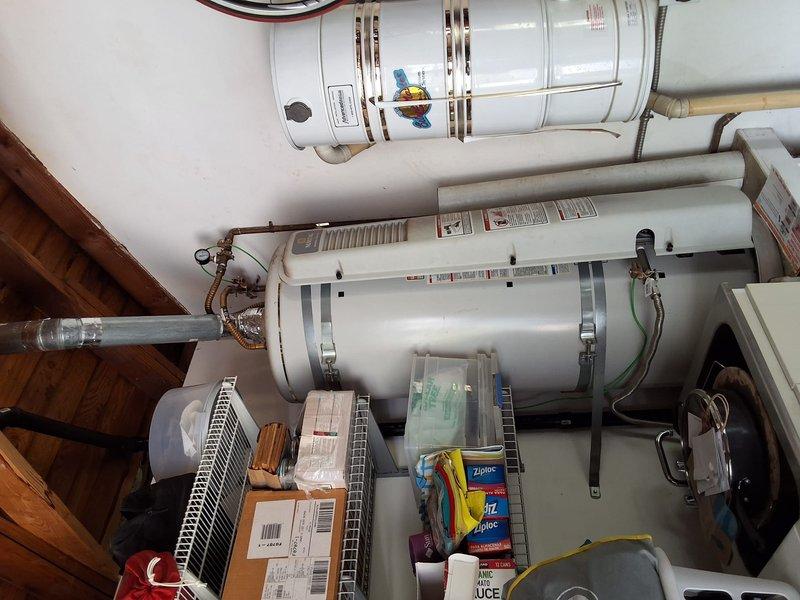 Performed inspection and estimate on approximately 15-year-old 60-gallon gas water heater in residential utility space. Unit showed age-related wear consistent with expected service life. Discussed replacement options with 50-gallon gas water heater model and reviewed permit requirements for installation. Provided ballpark estimate for standard replacement scope including removal of existing unit, installation of new water heater with proper venting and code-compliant connections, and disposal of old equipment. Documented existing installation configuration including mounting straps, gas valve condition, and plumbing connections via photographs. Reviewed available payment options including credit card and check acceptance.