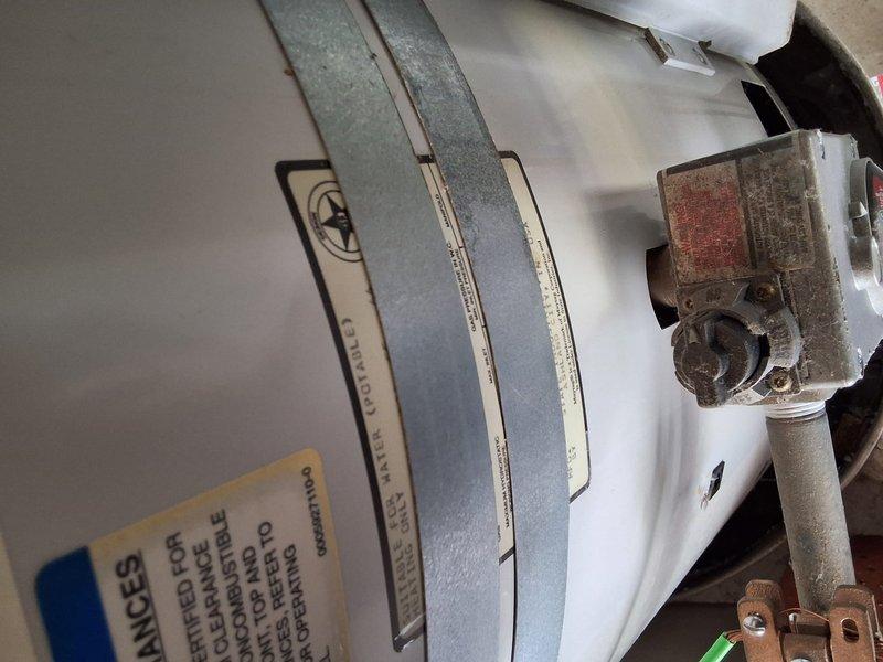 Performed inspection and estimate on approximately 15-year-old 60-gallon gas water heater in residential utility space. Unit showed age-related wear consistent with expected service life. Discussed replacement options with 50-gallon gas water heater model and reviewed permit requirements for installation. Provided ballpark estimate for standard replacement scope including removal of existing unit, installation of new water heater with proper venting and code-compliant connections, and disposal of old equipment. Documented existing installation configuration including mounting straps, gas valve condition, and plumbing connections via photographs. Reviewed available payment options including credit card and check acceptance.