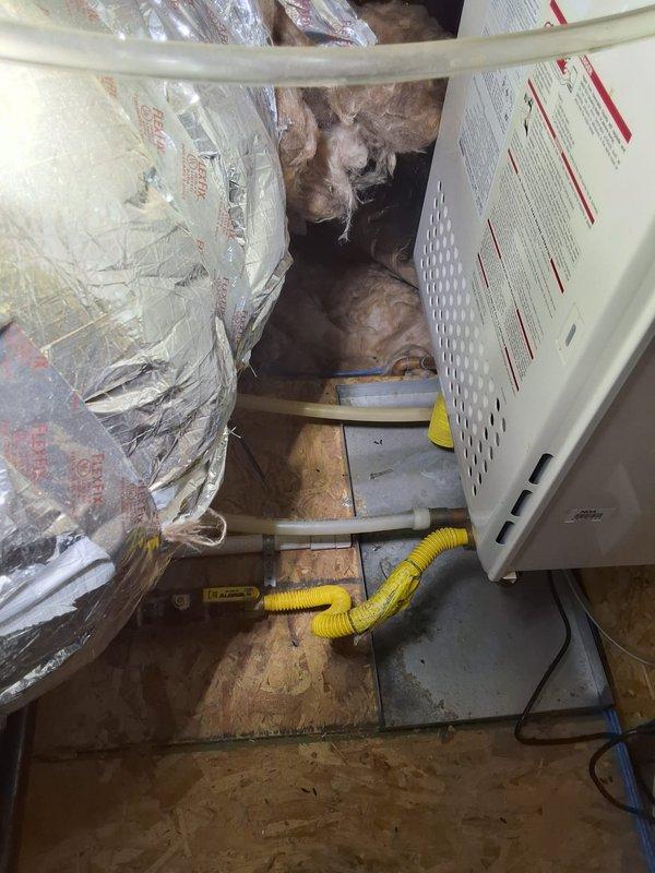 Responded to no hot water complaint at residential property. Accessed attic space to diagnose 2011 Noritz tankless water heater. Performed diagnostic evaluation of unit, inspected venting system, gas supply lines, and electrical connections. Examined flex duct routing and PVC condensate drainage system in attic installation. Identified issue preventing hot water production and completed necessary repairs to restore system operation.