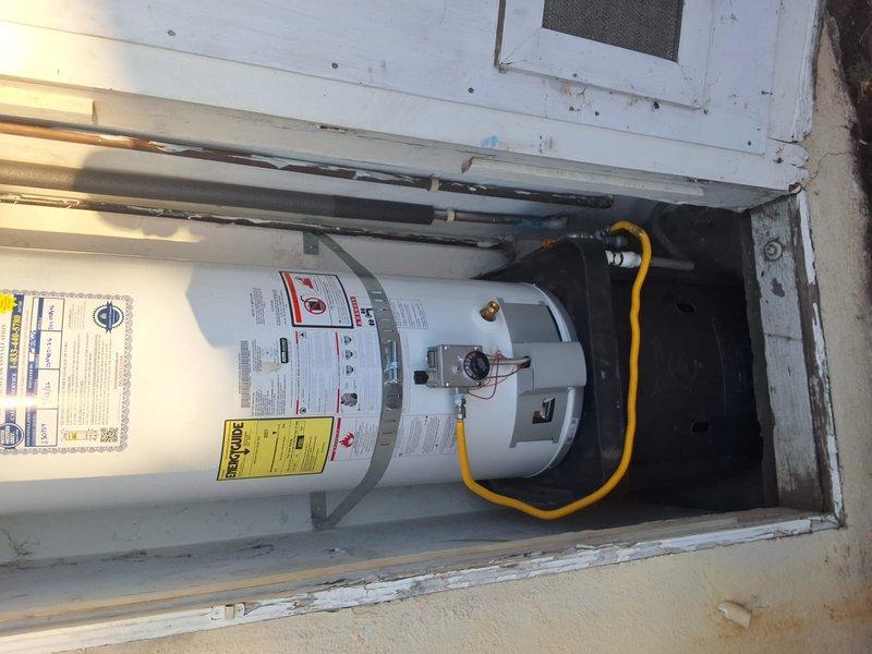 Replaced a 12-year-old 40-gallon gas water heater (model XG40T12DU36) that had reached the end of its service life. Removed the existing unit from the outdoor closet installation and installed a new 40-gallon gas water heater with proper venting, gas line connections using flexible yellow gas connector, and all required safety controls. Tested unit operation and verified all connections for proper function and code compliance.