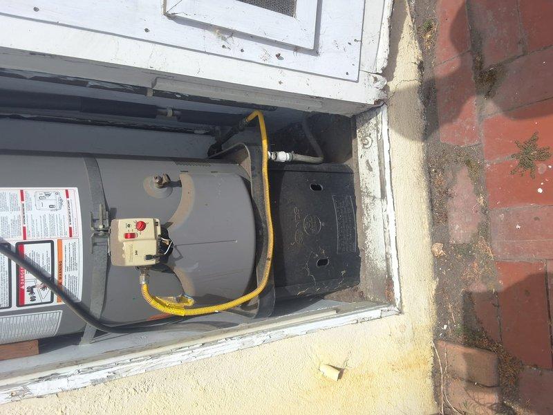 Replaced a 12-year-old 40-gallon gas water heater (model XG40T12DU36) that had reached the end of its service life. Removed the existing unit from the outdoor closet installation and installed a new 40-gallon gas water heater with proper venting, gas line connections using flexible yellow gas connector, and all required safety controls. Tested unit operation and verified all connections for proper function and code compliance.
