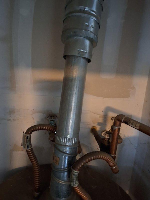 Replaced defective 15+ year old Bradford White 50-gallon natural gas water heater, model U45036FRN, serial number NA14396449, rated at 40,000 BTU/hr input. Original unit had failed burner assembly with replacement parts unavailable for the discontinued model, necessitating complete unit replacement. Removed old water heater and installed new 50-gallon natural gas atmospheric vent unit with proper venting connections and gas line hookups. Connected flexible gas supply lines, installed new exhaust vent piping with secure metal band clamps at coupling points, and verified all connections for proper fit and safety compliance. Tested new unit operation, confirmed proper ignition, burner function, and venting. Ensured installation met manufacturer specifications and local code requirements. Unit operational and providing hot water upon completion.