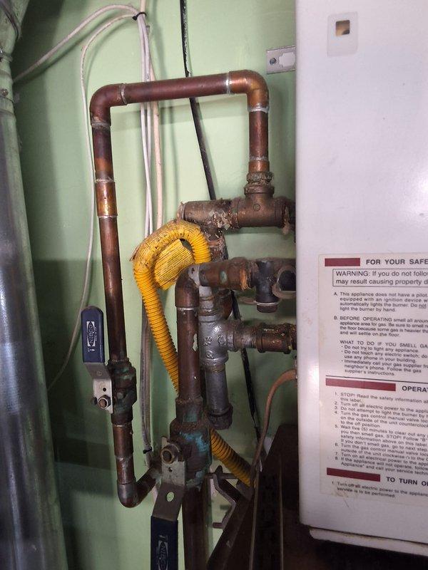 Responded to service call for leaking tankless water heater with no available model or age information. Conducted thorough inspection of existing plumbing assembly, which revealed aged copper piping with significant oxidation, corroded fittings, and a deteriorating flexible connector system. Documented equipment condition through photography, discussed permit requirements with property owner, and provided professional assessment recommending full system replacement due to extent of deterioration and active leak condition.
