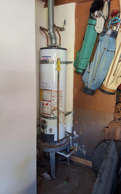 Responded to no hot water condition at residential property. Removed and disposed of existing 30-gallon gas water heater that had failed. Installed new 30-gallon atmospheric vent gas water heater model GN30T1-3-6 in utility area. Connected copper supply lines, gas line with yellow valve, and exhaust venting system. Secured unit with seismic straps per code requirements. Mounted water heater on elevated stand. Tested all connections for proper operation and verified hot water delivery. Ensured all safety labels and warning stickers remained visible and intact. Work performed in compliance with permitting requirements.