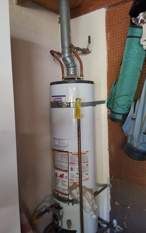 Responded to no hot water condition at residential property. Removed and disposed of existing 30-gallon gas water heater that had failed. Installed new 30-gallon atmospheric vent gas water heater model GN30T1-3-6 in utility area. Connected copper supply lines, gas line with yellow valve, and exhaust venting system. Secured unit with seismic straps per code requirements. Mounted water heater on elevated stand. Tested all connections for proper operation and verified hot water delivery. Ensured all safety labels and warning stickers remained visible and intact. Work performed in compliance with permitting requirements.
