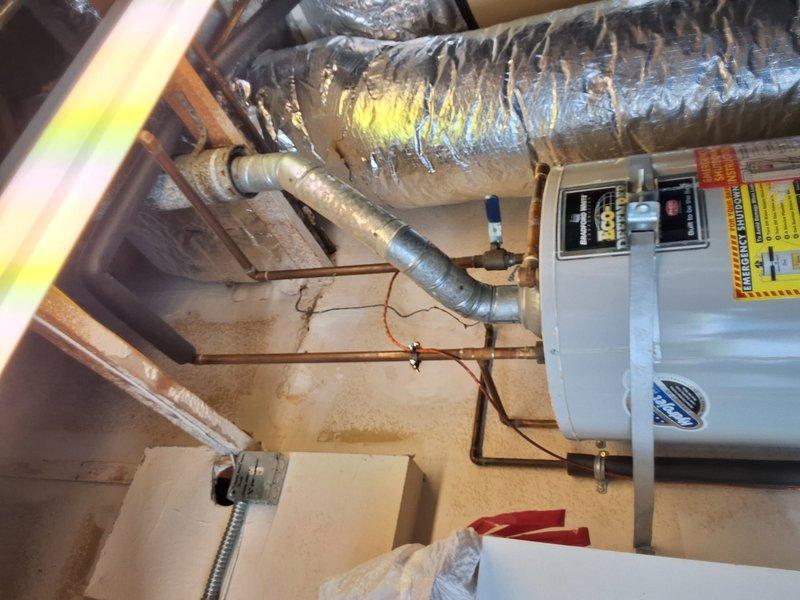 Performed inspection on a 50-gallon gas water heater reported to be leaking. Conducted visual assessment of the unit and surrounding HVAC equipment in the basement utility area. Utilized diagnostic pressure gauges to test system integrity and identify the source of the leak. Documented equipment condition with photographs showing ductwork, air handler, and testing procedures. Discussed permit requirements with property owner and provided a rough estimate for necessary repairs or replacement. Reviewed available payment options to complete the work.