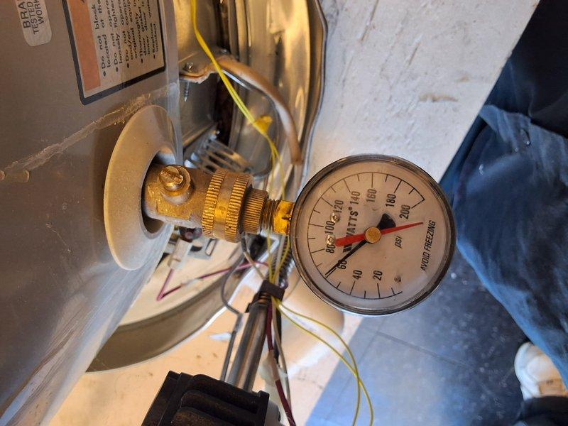 Performed inspection on a 50-gallon gas water heater reported to be leaking. Conducted visual assessment of the unit and surrounding HVAC equipment in the basement utility area. Utilized diagnostic pressure gauges to test system integrity and identify the source of the leak. Documented equipment condition with photographs showing ductwork, air handler, and testing procedures. Discussed permit requirements with property owner and provided a rough estimate for necessary repairs or replacement. Reviewed available payment options to complete the work.
