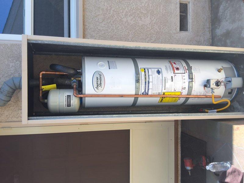 Replaced 40-gallon gas water heater with new GN40T1-3-6 unit in outdoor wooden enclosure. Installed new dielectric unions at water connections and sweat ball valve as requested. Reconnected existing expansion tank to new system, verified all gas line connections, and tested pressure relief valve operation upon completion.