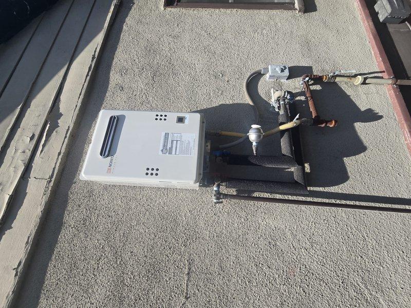 Performed routine maintenance flush on a natural gas tankless water heater unit model NNR662ODNG originally installed in February 2023. The unit is mounted on an exterior rooftop location with copper piping configuration including pressure relief valve connections. Completed descaling flush procedure to remove mineral buildup and ensure optimal heat exchanger performance and efficiency. Inspected all gas line connections, water supply lines, and venting components for proper operation. Unit tested successfully following maintenance and returned to normal operation with no issues identified.