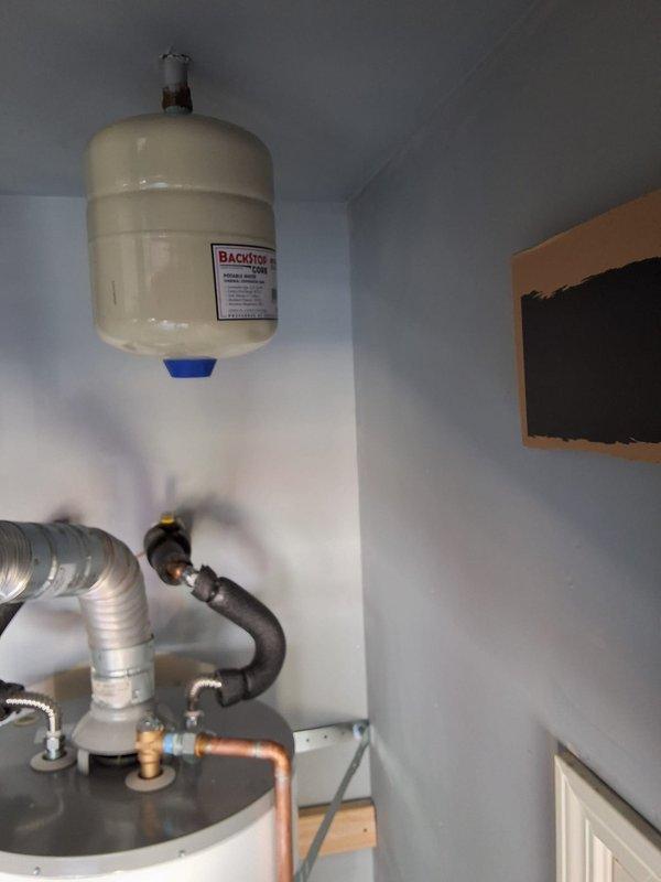 Replaced a 50-gallon gas water heater (model GN50T1-3-6) in garage due to slow leak. Installation included proper venting with metallic flexible duct, gas line connections with braided flexible conduit, copper water line connections, wall-mounted expansion tank, and drain pan for code compliance. All work performed with permit and according to local building codes.