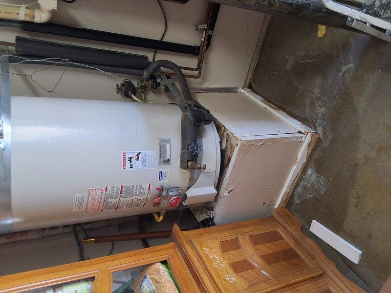 Responded to service call for leaking residential gas water heater with active bottom tank leak. Removed and disposed of failed approximately 50-gallon gas-fired water heater with undetermined model and serial number. Installed new 50-gallon gas water heater with proper venting, gas line connections, and water supply piping. Configured unit with code-compliant temperature and pressure relief valve discharge piping, secured all gas connections, and verified proper combustion air supply. Discussed permit requirements and obtained necessary permits for installation. Presented alternative tankless water heater options for future consideration. Tested all connections for leaks, verified proper gas pressure and burner operation, and confirmed adequate hot water delivery throughout residence upon completion.