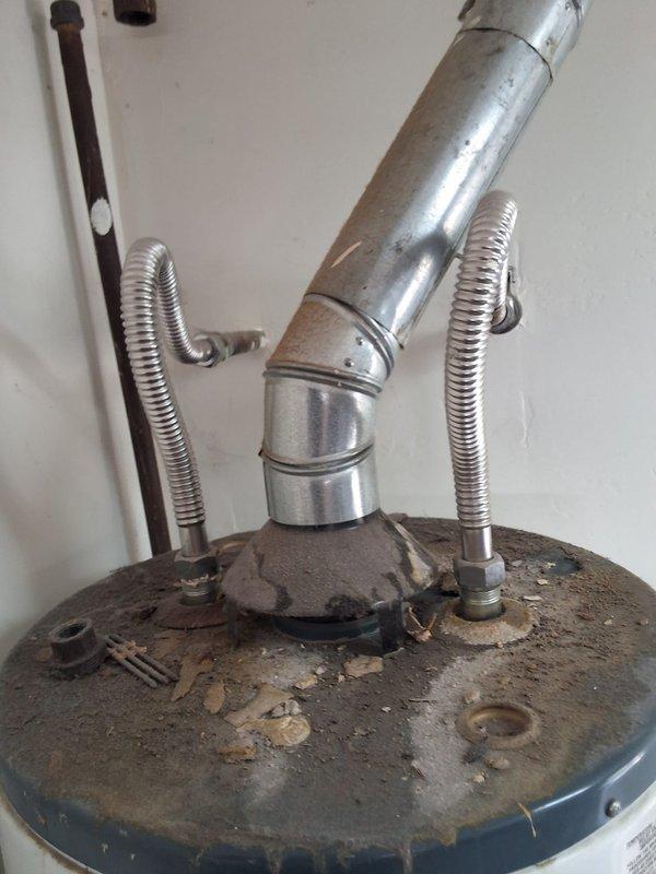 Responded to service call for residential water heater replacement. Upon arrival, inspected existing 18-year-old 40-gallon gas water heater model 22V40F1, which showed extensive corrosion, rust buildup, and mineral deposits on the tank top and surrounding components. Tank had reached end of service life and required immediate replacement. Provided customer with estimate for new 40-gallon gas water heater installation, with pricing range including permit requirements. Documented existing equipment condition with photographs showing severe deterioration of tank surfaces and venting components. Scheduled installation appointment for Saturday with arrival window between 1:00 PM and 4:00 PM. Advised customer of permit necessity for replacement work to ensure compliance with local building codes and regulations.