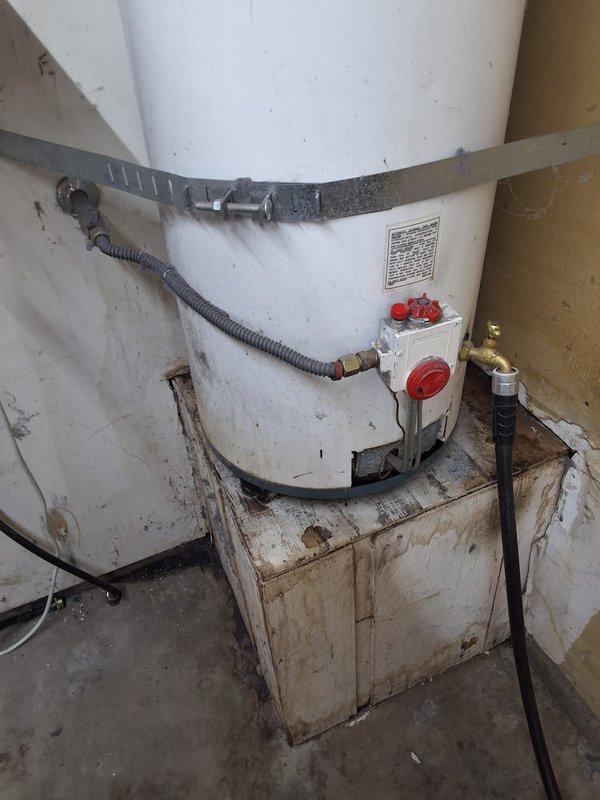 Responded to a leaking 40-gallon gas water heater located in the garage. Removed and disposed of the failed Rheem unit and installed a new 40-gallon gas water heater with proper venting and connections. Secured the new tank with seismic strapping, connected gas supply line and water lines with shut-off valves, installed temperature and pressure relief valve with discharge pipe, and verified all connections for proper operation and code compliance.