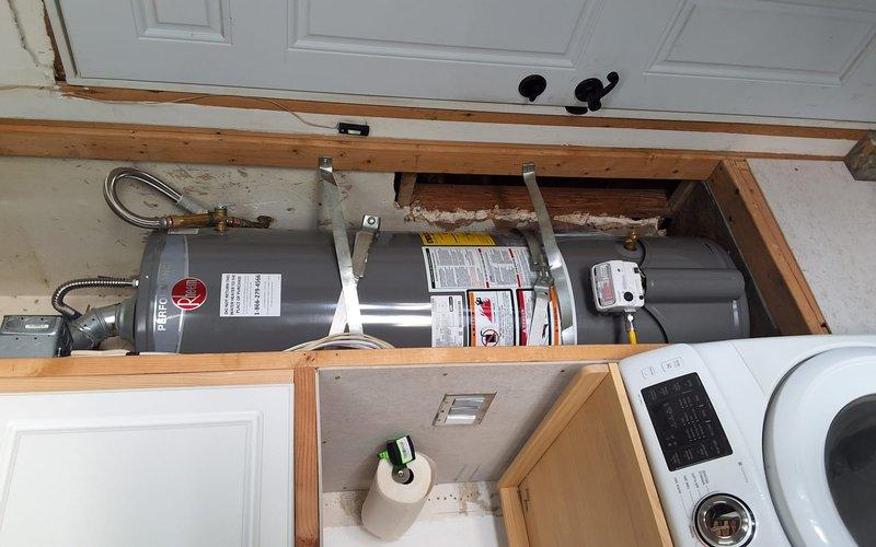 Responded to service call for leaking 40-gallon gas water heater. Performed inspection of existing Rheem unit installed in utility closet with exposed framing. Assessed leak condition and determined unit requires replacement. Provided estimate for new gas water heater installation using model GN40T1-3-6, discussed permit requirements and necessary code compliance modifications, and documented existing installation configuration with photographs. Scheduled follow-up appointment for replacement work.