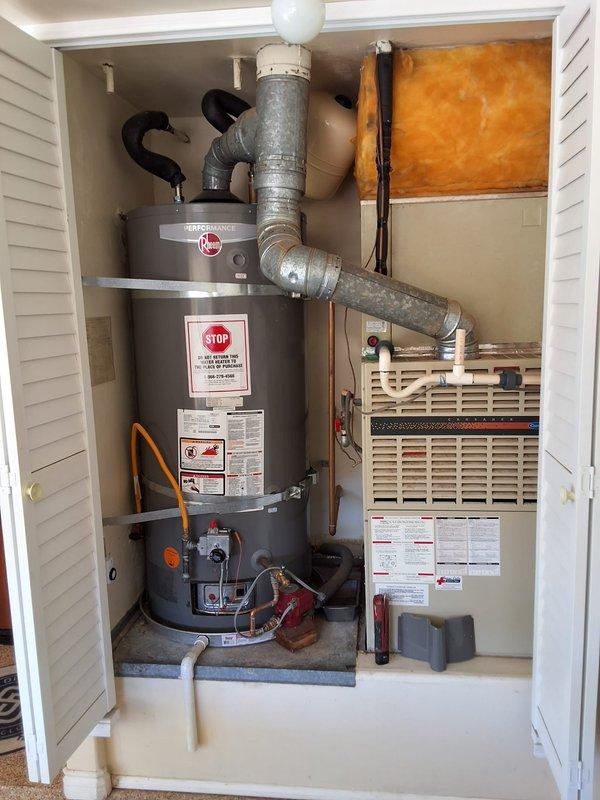 Responded to service call for Rheem water heater experiencing ignition problems. Removed and replaced existing 75-gallon gas water heater (model XP75T06ST76UI, serial #9362123998) with new Rheem Performance model GS675URRS in utility closet installation. Connected all water supply lines, gas line, and venting system per manufacturer specifications. Installed proper flue venting with galvanized ductwork extending through ceiling penetration. Tested all connections for leaks, verified proper gas ignition sequence, and confirmed adequate combustion air supply through louvered closet doors. Advised customer of permitting requirements for water heater replacement. Unit operational and producing hot water upon departure.