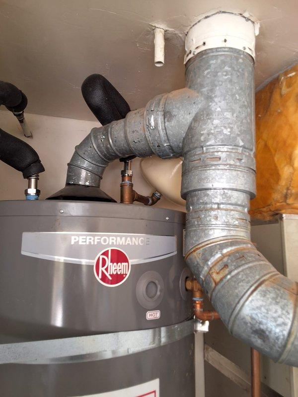 Responded to service call for Rheem water heater experiencing ignition problems. Removed and replaced existing 75-gallon gas water heater (model XP75T06ST76UI, serial #9362123998) with new Rheem Performance model GS675URRS in utility closet installation. Connected all water supply lines, gas line, and venting system per manufacturer specifications. Installed proper flue venting with galvanized ductwork extending through ceiling penetration. Tested all connections for leaks, verified proper gas ignition sequence, and confirmed adequate combustion air supply through louvered closet doors. Advised customer of permitting requirements for water heater replacement. Unit operational and producing hot water upon departure.
