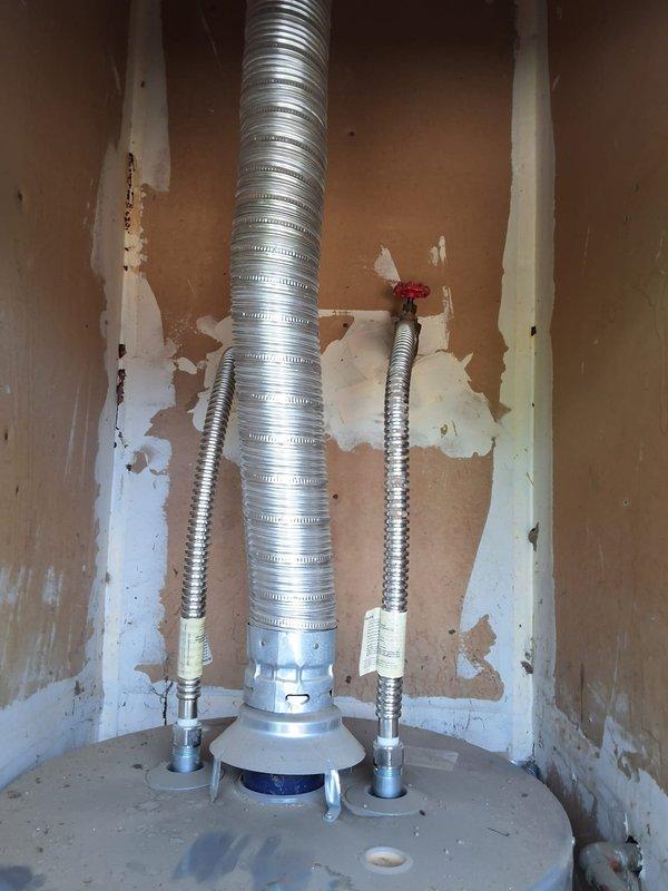Responded to no hot water condition and completed full replacement of failed 40-gallon gas water heater with new GN40T1-3-6 model unit. Installation included proper venting with aluminum flexible duct, connection of water supply lines with shutoff valves, gas line hookup, and all required code modifications. Permitting was obtained and all work completed to current residential plumbing standards.