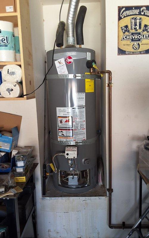 Responded to no hot water condition at residential property. Removed and replaced failed 2016 Rheem XG48T06EN40U1 atmospheric vent water heater with new Rheem GN50T1-3-6 50-gallon natural gas unit. Installed unit on concrete platform in garage utility area with proper venting through flexible metallic duct. Connected copper supply and discharge lines with code-compliant installation including TPR valve, expansion tank provisions, and gas line connections. Applied insulation to hot water piping connections. Verified proper combustion venting, tested all connections for leaks, and confirmed unit operation. Obtained permit for installation to meet local code requirements. Unit tested and operational upon completion.