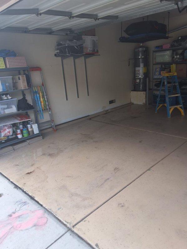 Responded to property management work order for reported leaking water heater. Upon arrival, located 40-50 gallon gas water heater in residential garage. Performed thorough inspection and evaluation of unit to identify source of leak and assess overall condition. Documented findings with photographic evidence showing garage layout and floor conditions with visible water staining and discoloration on concrete surface near unit location. Contacted office from site to report evaluation findings and await pricing approval per property management protocol before proceeding with recommended repairs or replacement.