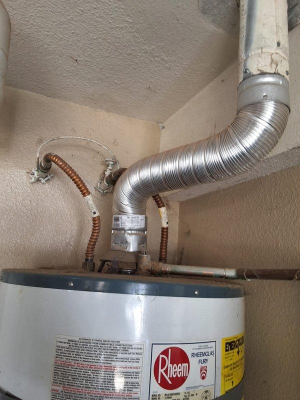 Performed inspection and estimate on 20-year-old Rheem water heater model 41ZR50N currently functioning properly. Customer requested evaluation for conversion from traditional tank-style water heater to tankless system. Discussed permit requirements for tankless installation and provided ballpark estimate range for complete tankless water heater swap-out, including removal of existing unit, installation of new tankless system, and necessary modifications to venting, gas lines, and electrical connections. Documented current installation with photos showing existing venting configuration with flexible aluminum ductwork, copper supply lines, and pressure relief valve assembly.