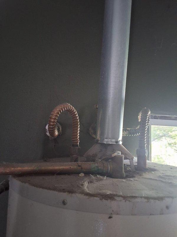 Responded to report of water heater leaking in garage. Inspected SG40T12XA01 unit and documented conditions with photos showing active installation with ceiling access point where plumbing penetrates structure and full water heater assembly with venting and gas connections. Discussed repair versus replacement options, permit requirements, and provided ballpark estimate for necessary work.