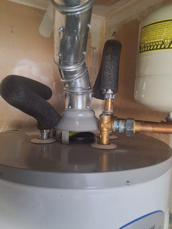 Responded to warranty call for American Standard water heater (Model GN50YT1-3-6) installed three months prior where pilot light would not relight after customer returned from vacation. Inspected gas control valve, thermocouple, and pilot assembly; successfully relit pilot and verified proper ignition sequence and burner operation. Unit tested and confirmed operational with all safety controls functioning correctly.