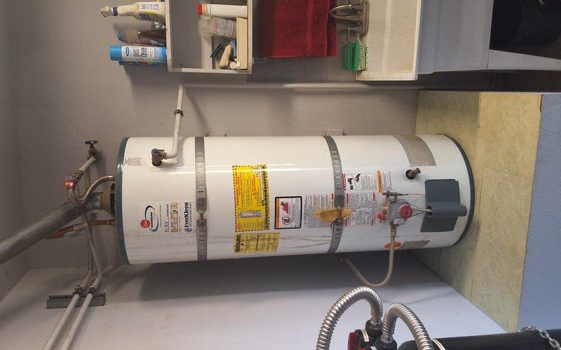 Performed preventative maintenance inspection on a 2006 Rheem 50-gallon gas water heater (Model: 42V50 36EF, Serial: 0405508370). Evaluated overall unit condition, plumbing connections, pressure relief valve operation, and venting system integrity. Documented existing installation with seismic strapping and copper piping configuration. Provided estimate for water heater replacement and discussed permit requirements for future installation work.