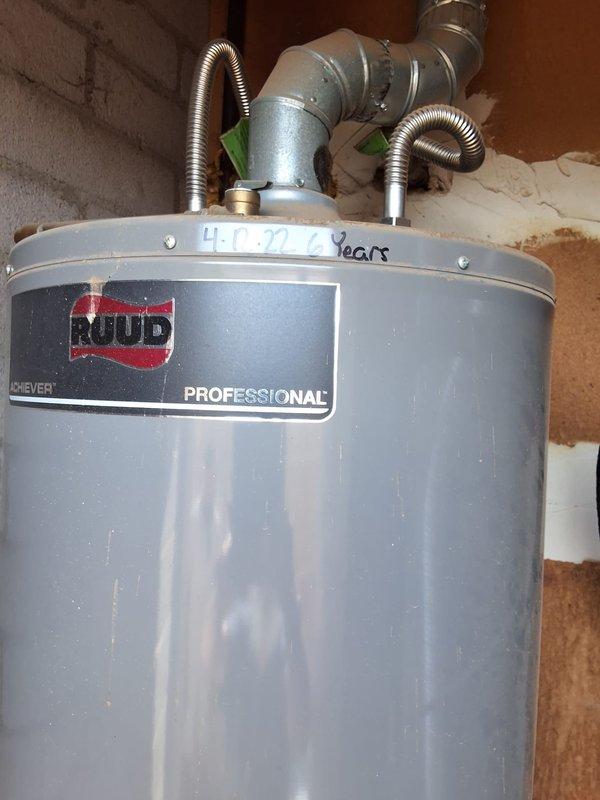 Responded to return customer request to assess water heater replacement needs for triplex property. Inspected existing Ruud Professional 40-gallon natural gas water heater, manufactured March 2022, model 40 NORT 11, serial number M0820283838. Unit marked as 4 years old and located in basement utility area with standard venting and plumbing connections. Confirmed property has single water heater serving the triplex rather than three separate units. Documented equipment specifications, installation configuration, and current condition through photographic inspection. Provided replacement options and recommendations for gas water heater upgrade.