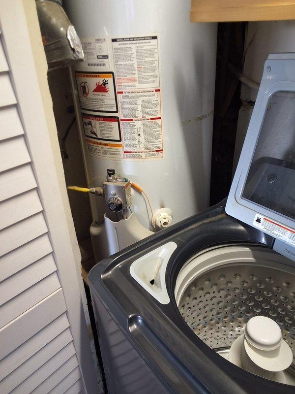 Responded to no hot water complaint on 2012 GE water heater model GG48T06AXX00. Assessed unit and determined pilot light was extinguished; attempted relight service but recommended full replacement due to age and condition of twelve-year-old tank. Presented replacement option for GE model GN50T1 50-gallon gas water heater with 12-year warranty, advised customer of permit requirements for installation, and documented existing equipment configuration including gas line connections and utility room layout for future replacement scheduling.