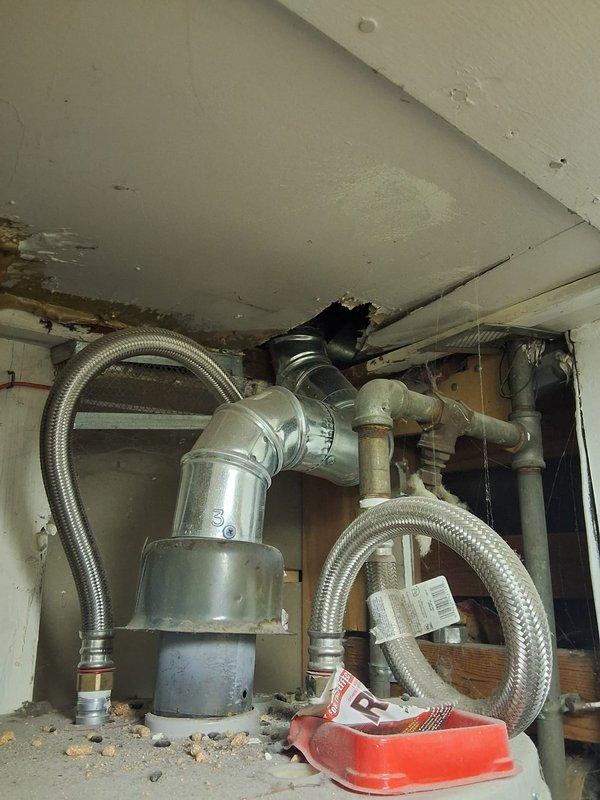 Responded to no hot water complaint on 2012 GE water heater model GG48T06AXX00. Assessed unit and determined pilot light was extinguished; attempted relight service but recommended full replacement due to age and condition of twelve-year-old tank. Presented replacement option for GE model GN50T1 50-gallon gas water heater with 12-year warranty, advised customer of permit requirements for installation, and documented existing equipment configuration including gas line connections and utility room layout for future replacement scheduling.