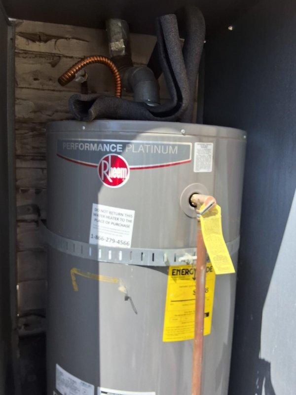 Responded to service call for gas leak at top of existing 40-50 gallon water heater. Performed inspection of Rheem Performance Platinum unit and confirmed active gas leak at upper connections. Provided customer with estimate options for both repair and complete unit replacement, discussed permit requirements for replacement installation, and documented equipment condition with photographs.