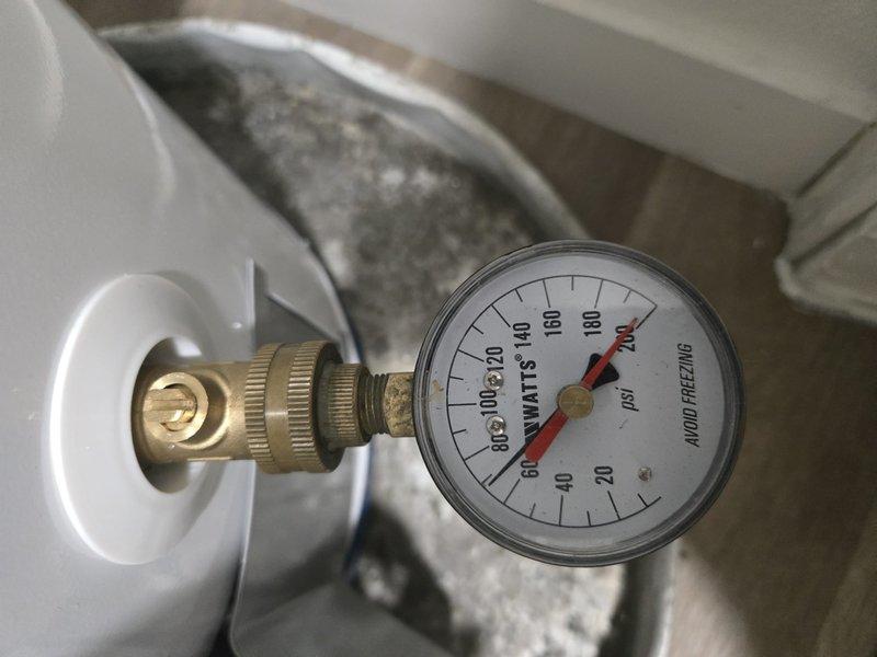 Responded to property management request for water heater replacement evaluation at multi-family residential unit. Accessed mechanical space and inspected existing 30-gallon gas water heater in interior closet configuration. Documented current system conditions including water supply pressure readings via installed gauge showing operational parameters within normal range. Observed existing water filtration system with dual-stage filter housings and braided supply lines in serviceable condition. Completed photographic documentation of equipment and surrounding infrastructure. Contacted office from site with findings per protocol for pricing approval before proceeding with replacement work.