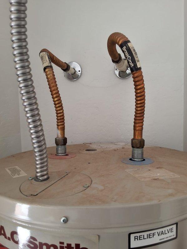 Responded to service call for insufficient water temperature on AO Smith electric water heater model ECT50T200. Performed diagnostic evaluation of unit including inspection of heating elements, thermostat operation, and electrical connections. Documented existing installation with copper flex supply lines and standard residential configuration. Provided customer with repair options and replacement estimate based on findings from diagnostic assessment.