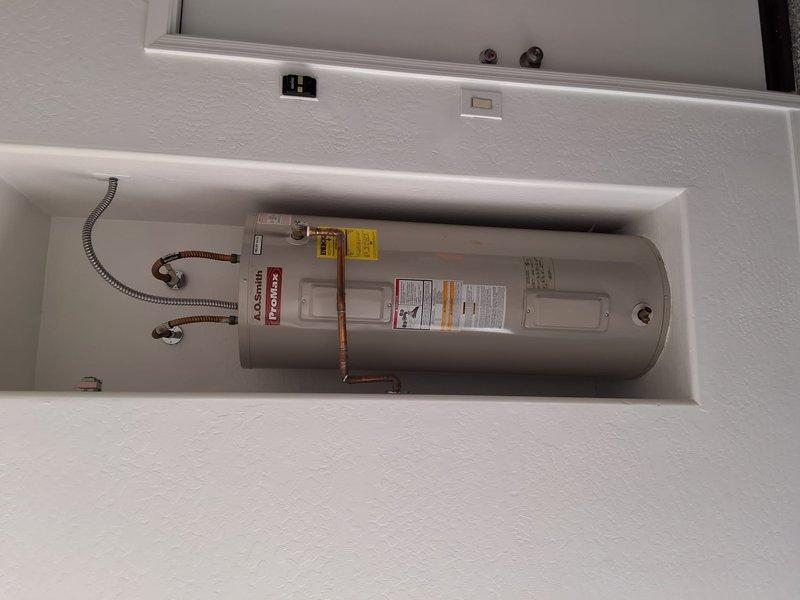Responded to service call for insufficient water temperature on AO Smith electric water heater model ECT50T200. Performed diagnostic evaluation of unit including inspection of heating elements, thermostat operation, and electrical connections. Documented existing installation with copper flex supply lines and standard residential configuration. Provided customer with repair options and replacement estimate based on findings from diagnostic assessment.