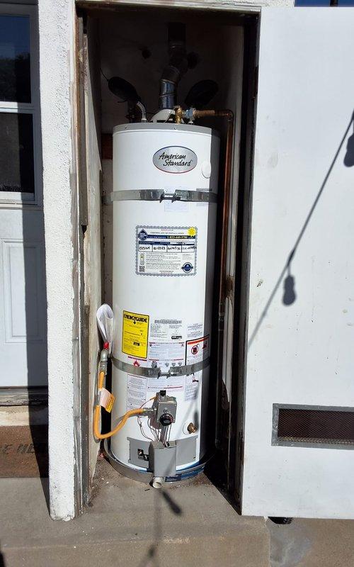 # WHO Warranty Service - Water Heater

Responded to customer complaint of inconsistent hot water on American Standard 40-gallon natural gas water heater, Model GN40T136NAT, Serial #L2505834, under first-year warranty coverage. Performed comprehensive diagnostic inspection of unit installed in exterior alcove. Verified proper gas supply connection via flexible gas line to control valve assembly. Inspected burner assembly, thermocouple, and pilot light operation for proper combustion and flame characteristics. Checked temperature and pressure relief valve for proper operation and verified discharge piping configuration. Tested thermostat control settings and calibration at gas valve control unit. Examined water inlet and outlet connections at top of tank for flow restrictions or sediment accumulation. Verified proper venting through rooftop termination with mesh screen and confirmed adequate combustion air supply through ventilation grille. Inspected heat exchanger flue tube and draft in