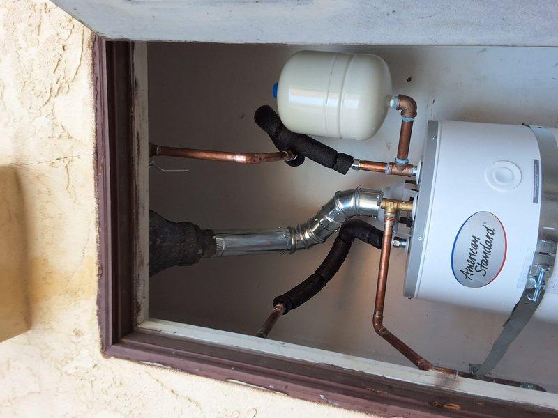 Responded to service call for water heater with pilot light failure on model SG40T12XA01. Upon inspection, determined unit was beyond economical repair due to age and condition. Removed and properly disposed of existing 40-gallon conventional tank water heater. Installed new American Standard residential water heater with complete plumbing connections including copper supply lines, expansion tank, temperature and pressure relief valve, and proper venting. Applied pipe insulation to hot and cold water lines for energy efficiency. Replaced corroded shut-off valve that showed significant oxidation and deterioration. Addressed water damage concerns in installation area. Secured necessary permit for Imperial Beach jurisdiction prior to installation. Tested all connections for leaks, verified proper operation of new unit, and confirmed adequate hot water delivery throughout the residence.
