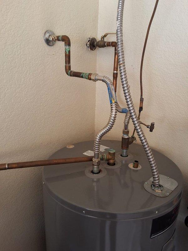 Responded to residential water heater leak. Removed and disposed of failed 2017 Rheem PROE50M2 50-gallon electric water heater exhibiting severe tank corrosion and active leaking from lower access panel area. Installed new Rheem RE350T6 50-gallon electric water heater as replacement unit. Connected hot and cold water supply lines, installed new pressure relief valve with discharge piping, verified all electrical connections to code specifications, and tested unit operation. Cleaned work area and removed all debris. System operational upon departure.
