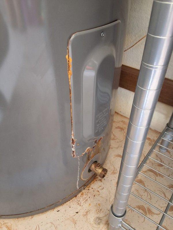Responded to residential water heater leak. Removed and disposed of failed 2017 Rheem PROE50M2 50-gallon electric water heater exhibiting severe tank corrosion and active leaking from lower access panel area. Installed new Rheem RE350T6 50-gallon electric water heater as replacement unit. Connected hot and cold water supply lines, installed new pressure relief valve with discharge piping, verified all electrical connections to code specifications, and tested unit operation. Cleaned work area and removed all debris. System operational upon departure.