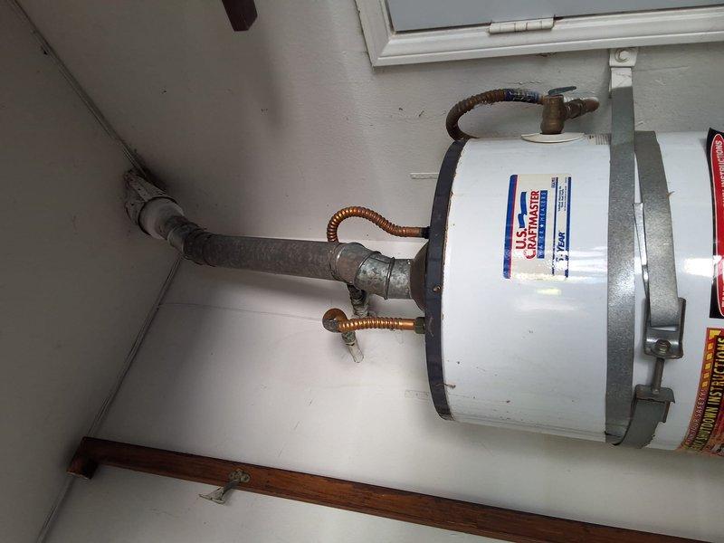 Completed replacement of aging residential 40-gallon gas water heater located in garage with new U.S. Craftmaster unit. Upgraded installation to meet current code requirements for garage installations, including proper seismic strapping with metallic safety bracket and compliant venting connections. Installed new flexible copper water line connectors to both hot and cold supply lines with brass fittings, ensuring secure connections and proper water flow. All work performed to current residential plumbing and safety codes for garage-mounted water heating equipment.
