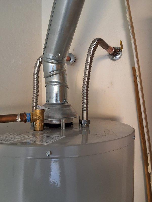 Responded to service call for water leak on residential water heater unit model RG250T6N, serial number WC4485503. Upon inspection, identified potential leak source as either the tank itself or the temperature and pressure relief valve. Documented unit condition with photographs showing gas control assembly, pilot light system, electrical connections, and venting configuration. Inspected all plumbing connections including copper supply lines and brass fittings for signs of moisture or corrosion. Presented customer with repair and replacement options, including T&P valve replacement with associated labor or full tank replacement. Customer to advise on preferred course of action for scheduling follow-up service.