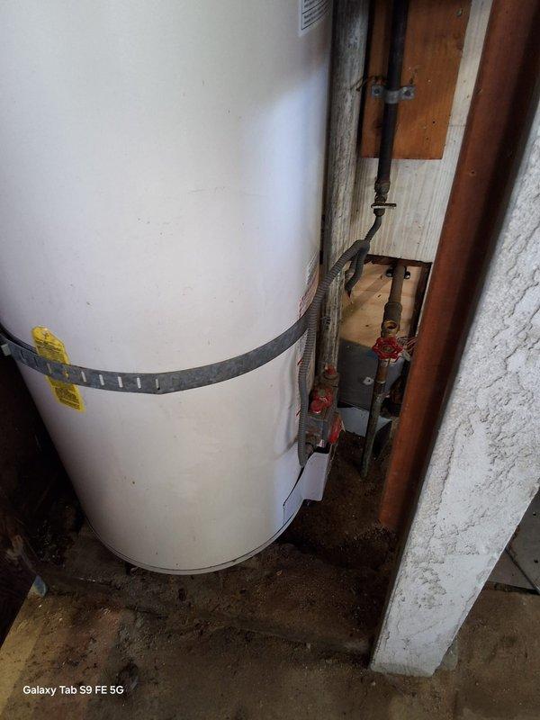 Replaced a 24-year-old leaking 40-gallon gas water heater (Model: 5G40T12XA01, Serial: GELN0102120804) in residential basement utility area. Removed existing failed unit, installed new 40-gallon gas water heater with proper seismic strapping, connected copper supply lines and gas piping, installed temperature and pressure relief valve with discharge pipe, verified all connections for leaks, and tested unit operation. Discussed permit requirements with customer's family representative and confirmed available payment methods.