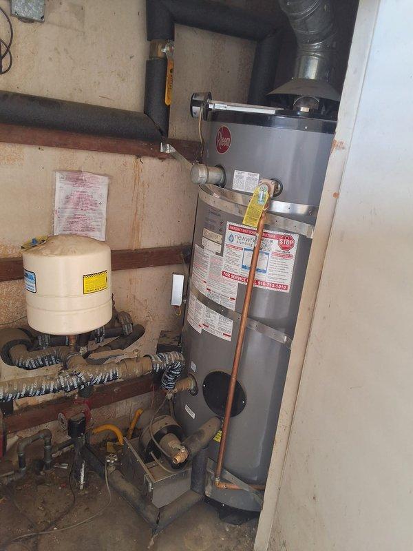 Responded to a commercial water heater service call for a 16-unit building experiencing slow hot water delivery to 8 units. Inspected dual 100-gallon gas water heater system consisting of an American Standard unit (Model D100199AS, 199K BTU) and a Rheem unit (Model A252307725, 199K BTU, installed 2023). Diagnosed recirculation pump malfunction affecting hot water distribution throughout the building. Evaluated pump operation, circulation loop integrity, and associated plumbing connections including copper piping, valves, and pressure relief components. Documented system configuration and identified necessary repairs to restore proper hot water recirculation and delivery times to all affected units.