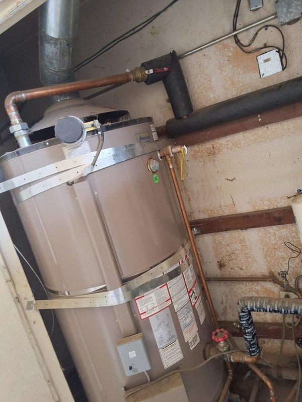 Responded to a commercial water heater service call for a 16-unit building experiencing slow hot water delivery to 8 units. Inspected dual 100-gallon gas water heater system consisting of an American Standard unit (Model D100199AS, 199K BTU) and a Rheem unit (Model A252307725, 199K BTU, installed 2023). Diagnosed recirculation pump malfunction affecting hot water distribution throughout the building. Evaluated pump operation, circulation loop integrity, and associated plumbing connections including copper piping, valves, and pressure relief components. Documented system configuration and identified necessary repairs to restore proper hot water recirculation and delivery times to all affected units.