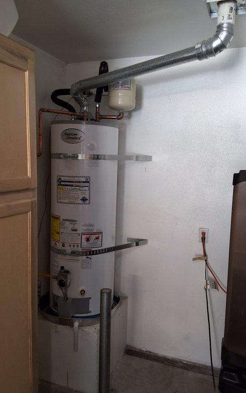 Replaced existing 50-gallon gas water heater, originally installed in 2005, with new Diamond Defender unit in residential utility closet. Installation included proper venting with flexible metal ductwork, mounting of expansion tank, installation of WATTS pressure relief valve and gauge assembly, and connection of all water supply lines and gas piping per manufacturer specifications and local code requirements.