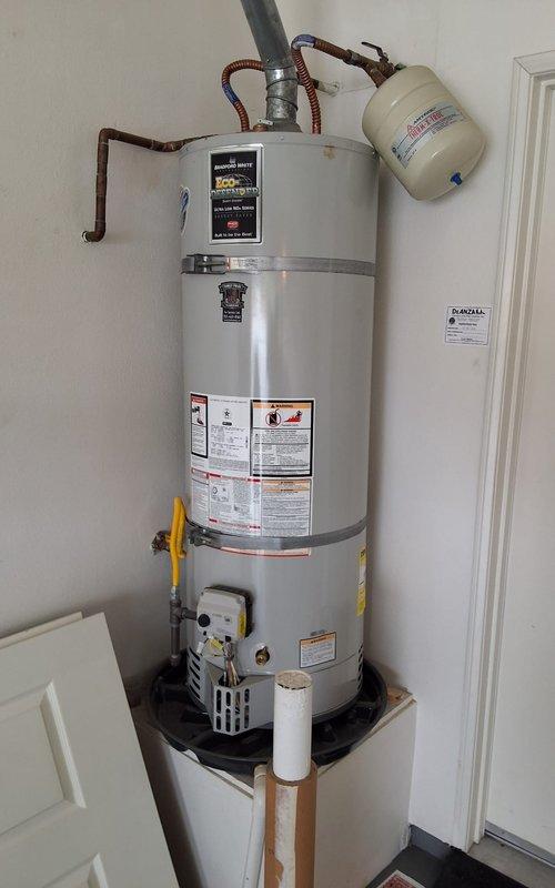 Performed comprehensive maintenance service and safety inspection on 2021 Bradford White URG240T6N atmospheric gas water heater. Completed full tank flush to remove sediment buildup and improve heating efficiency. Conducted thorough safety check including inspection of gas control valve assembly, temperature and pressure relief valve, burner assembly operation, flue venting system, and expansion tank. Verified proper function of all controls, checked for gas leaks at connections, confirmed adequate combustion air supply, and inspected copper water line connections and flexible gas connector for any signs of wear or corrosion. All components found to be operating within manufacturer specifications with no safety concerns identified.