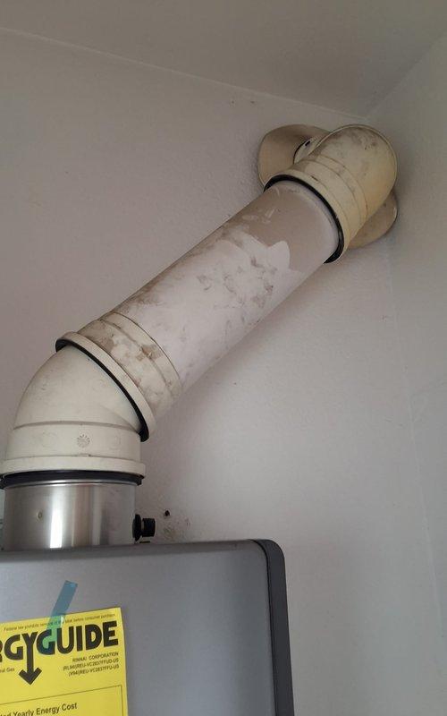 Performed preventive maintenance inspection on a 5-year-old Rinnai tankless water heater system. Evaluated unit condition, plumbing connections including copper piping with isolation valves and pressure gauge, flexible gas line with shutoff valve, and exhaust venting system. Confirmed unit is under warranty coverage, discussed permit requirements for future replacement work, and provided estimate for 50-gallon gas water heater installation with available payment options.