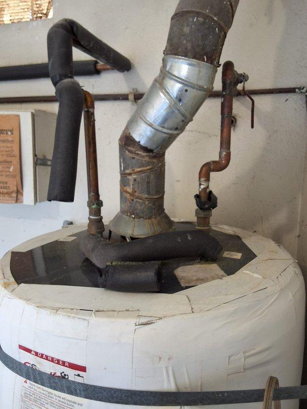 Conducted on-site commercial estimate for water heater replacement at multi-unit residential property. Assessed existing light-duty water heater showing significant age-related deterioration including corroded flue pipe, oxidized copper connections, and general wear throughout the system. Documented equipment condition and specifications, coordinated site access with property management, and provided insurance documentation and W-9 information as required for new commercial client.