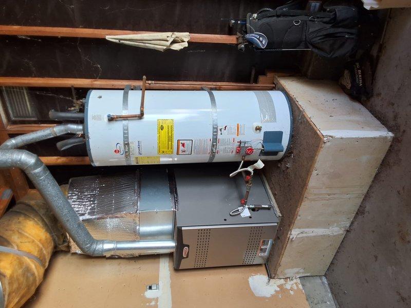 Replaced existing 50-gallon gas water heater from 2005 with new 40-gallon gas water heater in residential utility space. Disconnected and removed old unit, installed replacement with proper copper piping connections, secured unit with metal strapping per code requirements, and ensured all gas and water connections were properly sealed and tested. Customer was advised of permitting requirements for the installation and requested to schedule permit inspection at a later time.