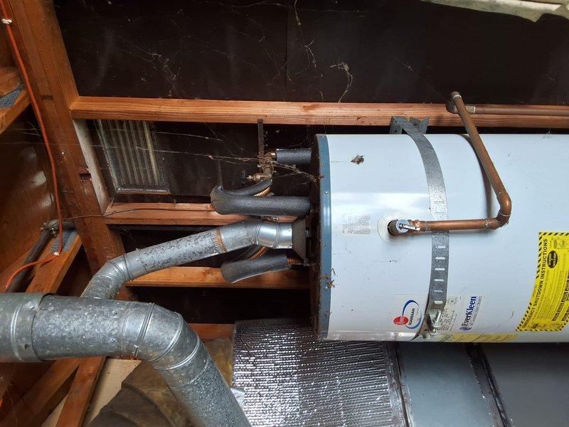 Replaced existing 50-gallon gas water heater from 2005 with new 40-gallon gas water heater in residential utility space. Disconnected and removed old unit, installed replacement with proper copper piping connections, secured unit with metal strapping per code requirements, and ensured all gas and water connections were properly sealed and tested. Customer was advised of permitting requirements for the installation and requested to schedule permit inspection at a later time.